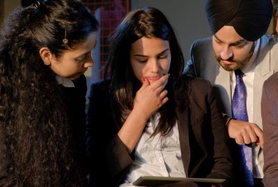 A closeup shot of Indian businessmen and businesswomen having an online group meeting at the office